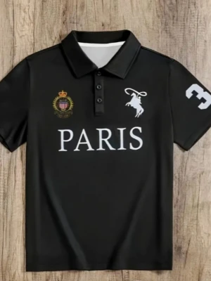 Svart Paris polo med tryck - Cool svart polo med krage och knappar framtill. Stort vitt Paris-tryck på bröstet, emblem med krona och en vit figur med lasso. Siffra 3 på ena ärmen. Perfekt för dig som gillar sportig och urban stil.