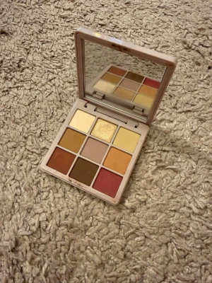 Modern Renaissance ögonskuggspalett - Modern Renaissance ögonskuggspalett från Anastasia Beverly Hills med nio nyanser i varma toner som guld, beige, brunt, orange och rosa. Paletten har en spegel i locket och kommer i en stilren, beige plastförpackning. Perfekt för kreativa ögonlooks.   Använd några gånger 