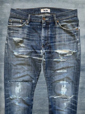 *GALNA* ACNE JEANS MED SLITNINGAR - Ett par helt stört snygga jeans från acne med helt galna slitningar! Modellen kallas ”Mod/The Rod” och sitter slim/straight! Storlek 30/32, hör av dig vid frågor!