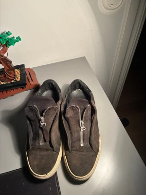 Svarta sneakers med dragkedja - Axel arigato, de är de skicket som de ser ut därför priset 