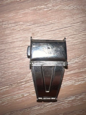Silverfärgat spänne till klocka adidas  - Säljer ett silverfärgat viklås från Omega till armbandsur. Låset är i metall och har Omegas logotyp ingraverad på ovansidan. Perfekt för dig som vill byta ut eller uppgradera spännet på din klocka. En svår tagen del som kan göra din klocka finare 150 till 350 säljer för 200  men är öppen för förhandling 