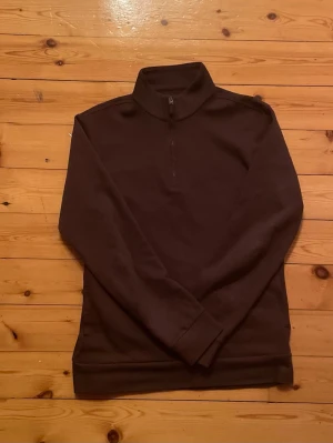 Mörkbrun halvzip tröja Ralph Lauren - Exclusive Ralph Lauren tröja, ÄKTA! Kvitto finns!!!! Mörkbrun tröja med halv dragkedja och hög krage. Tröjan har långa ärmar och ribbade muddar vid ärmslut och nederkant. Perfekt för lager på lager och enkel att matcha med olika outfits.