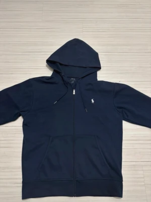 Polo ralph Lauren zip hoodie marin blå  - Marin blå zip hoodie från RL väldigt bra skick och passar alla stilar och funkar för dig som vill se bra ut i vardagen. Storlek M och pris kan diskuteras vid snabb affäf