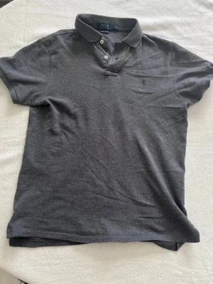 Ralph Lauren grå piké  - En slim fit grå Raffe piké i storlek M, perfekt till vår och sommar. 