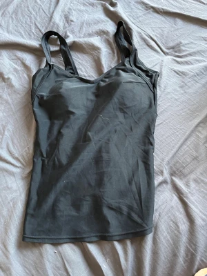 Svart baddräkt från Water Basics - Snygg svart baddräkt från Water Basics i storlek M. Klassisk modell med smala axelband och lätt v-ringad halsringning. Tillverkad i ett stretchigt material som sitter bekvämt och följsamt. Perfekt för stranden eller simhallen. Perfekt för dig som inte gillar att använda bikini topp och vill ha som ett minne istället.