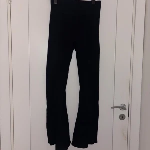 Svarta utsvängda tränings leggings - Svarta leggings med utsvängda ben och hög midja. Mjukt och stretchigt material som sitter skönt på kroppen. Perfekta för en trendig och avslappnad stil.