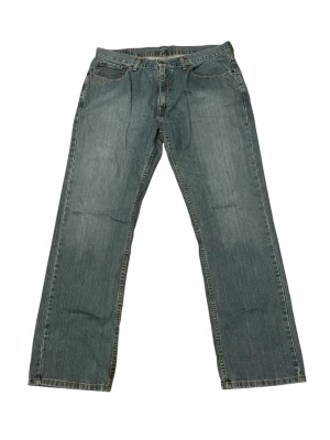 Vintage 559’s Fit Levi’s Jeans - Klassiska blå jeans med rak passform och fyra fickor. Jeansen har normal midja, dragkedjegylf och kontrastsömmar. Tillverkade i slitstark denim med en lätt tvättad look. Perfekta för en avslappnad stil.