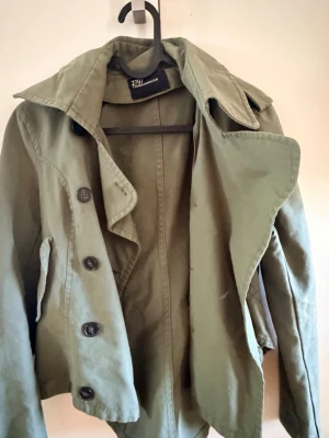 Grön trenchcoat  - Skit snygg grön trenchcoat som e perfekt till vår/höst🩷🩷🩷🌸🌸