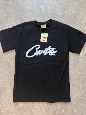 Svart t-shirt med vit textprint - Snygg svart t-shirt med vit grafisk text på bröstet. Klassisk rund halsringning och korta ärmar. Tillverkad i mjukt bomullsmaterial som känns skönt mot huden. Perfekt för en avslappnad och trendig stil. Perfect också för de som har storlek S