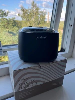 Svart vaxvärmare från Pearlwax - Snygg svart vaxvärmare från Pearlwax med digital display och touchknappar. Perfekt för att smälta vax till hårborttagning hemma. Kommer med originalkartong och har en modern, stilren design i plast.