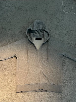 Grå zip hoodie Peak Performance - Snygg grå zip hoodie från Peak Performance med huva och dragskedja! Väldigt bra skick inte använd så många gånger. Nypris 1400! Säljer den för 450 kr kan gå ner till 270 kr möjligtvis!