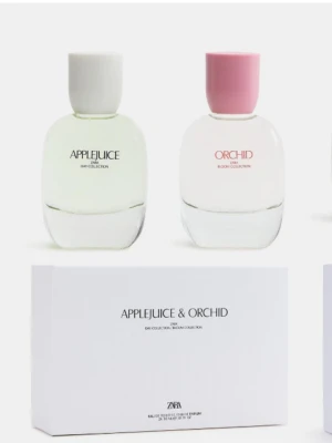 Zara Applejuice & Orchid parfymset - Parfymset med två flaskor från Zara: Applejuice med toner av äpple, pion och viol, samt Orchid med inslag av bergamott, orkidé och vanilj. Flaskorna är stilrena i glas med vita och rosa korkar. Perfekt för dig som gillar fräscha och blommiga dofter.