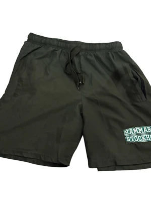 Hammarby shorts - Säljer ett par Hammarby shorts köpte på match! Säljer då dem är för små för mig och inte kommer till användning. Storlek M. En drag kedja har fastnat, går att fixa enkelt!