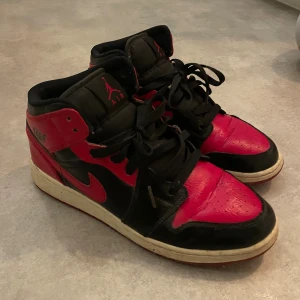Nike Air Jordan 1 High röd/svart 40 - Nike Air Jordan 1 High sneakers i klassisk röd och svart färg med vita sulor. Använda
