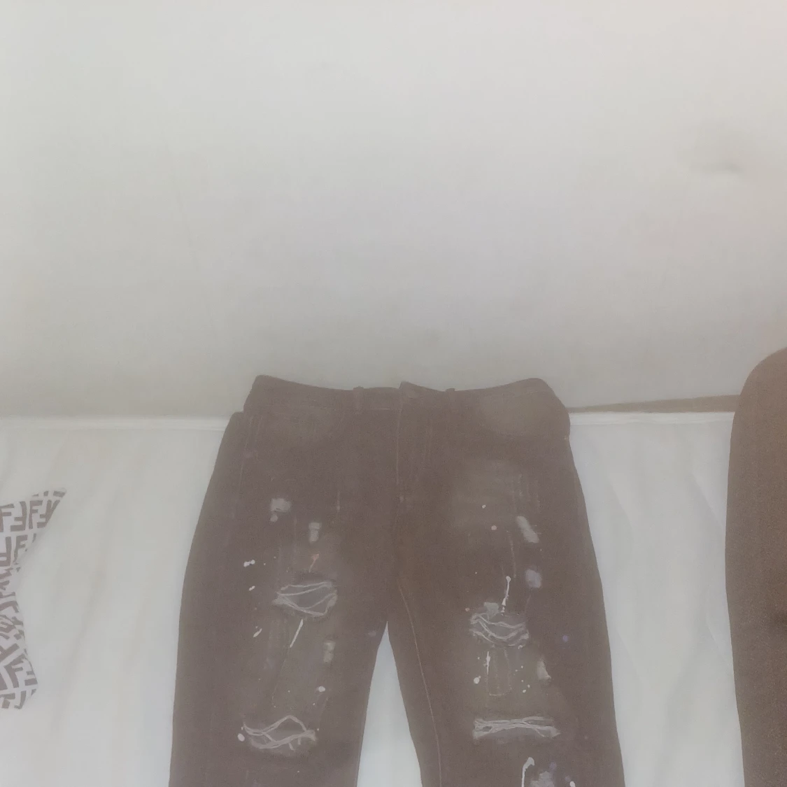 Svarta jeans med slitningar och färgstänk