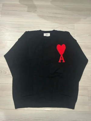 Svart stickad tröja från Ami Paris  - Säljer en otroligt fin stickad tröja från Ami Paris i Storlek M & Skick 10/10! Pris kan diskuteras!