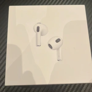Apple AirPods (3rd generation) med MagSafe-laddningsetui - Säljer ett par Apple AirPods (3rd generation) med MagSafe-laddningsetui. Produkten är i nyskick och levereras komplett i originalförpackning. Stöd för MagSafe och Qi-laddning, kompatibel med iOS, iPadOS och Mac. Perfekt för trådlös musik och samtal.