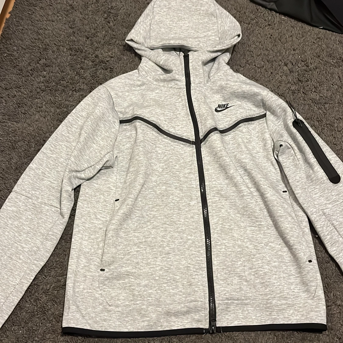 Grå vindjacka från Nike med huva