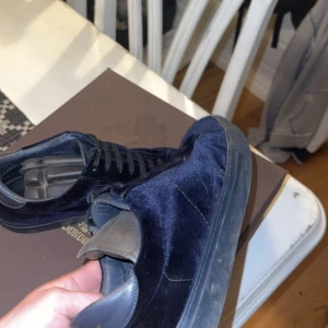 Dondup Skor - Säljer ett par riktigt snygga sneakers från Dondup i mörkblå sammet med matchande mörkblå skinnpaneler vid hälen. Skorna har rund tå, platt sula och klassisk snörning. Perfekt för dig som vill sticka ut med stilrena och grisch sneakers. För mer info och bilder hör av dig