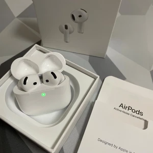 AirPods 4 - Snygga och välbevarade AirPods Pro med aktiv brusreducering. Komplett med originalförpackning och manual. Laddningsfodralet och hörlurarna ser ut att vara i nyskick utan synligt slitage eller repor. Perfekt för musik, samtal och träning.