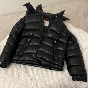 Moncler jacka - Bra skick, en svart vinterjacka modell maire, möts helst upp men om de inte går så skickar jag, säljer billigare för att den har jätte små repor och den där rosa grejen i jackan har lossnat!