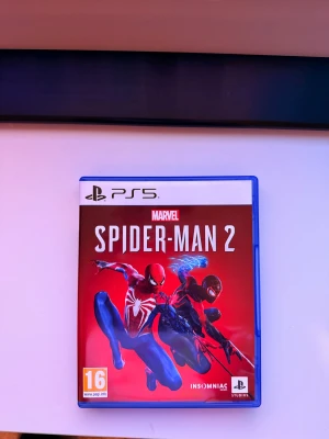Marvel's Spider-Man 2 PS5 - Marvel's Spider-Man 2 till PS5 i originalfodral. Skivan och fodralet är i mycket gott skick, inga synliga repor eller skador. Upplev Peter Parker och Miles Morales i ett actionfyllt äventyr. PEGI 16. Perfekt för samlare och fans av serien.