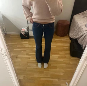 Blå lågmidjade jeans från  H&M Divided - Säljer ett par snygga blå jeans från H&M Divided i storlek 36. Modellen har bootcut-ben och är låga i midjan. Materialet är jeans med lite stretch för extra komfort. 