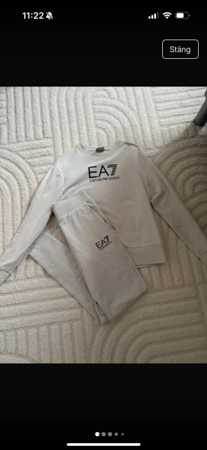 Beige EA7 Emporio Armani sweatshirt - Snygg beige sweatshirt från EA7 Emporio Armani med svart logotyptryck på bröstet. Tröjan har rund hals, långa ärmar och ribbade muddar vid ärmslut och nederkant. Perfekt för chill eller träning, mjukt material och stilren design. I storlek S 