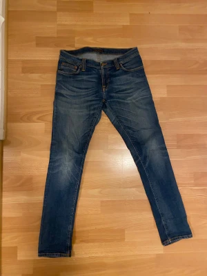 Nudie Jeans Tight Long John  - Snygga blå Nudie Jeans Tight Long John i storlek 31/32 med snygga slitningar. Passformen är slim som syns på 5 och 6. Kontakta gärna vid frågor!