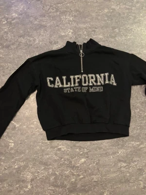 California hoodie - Säljer en California hoodie med zip uppe vid halsen.