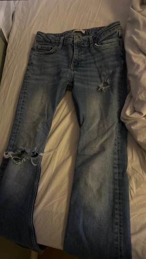 Blå jeans med egna gjorda håll  - Säljer ett par blå jeans från Gina Tricot i storlek 146. Hållen är egen gjorda men säljer för dom är alldeles för korta för mig💗