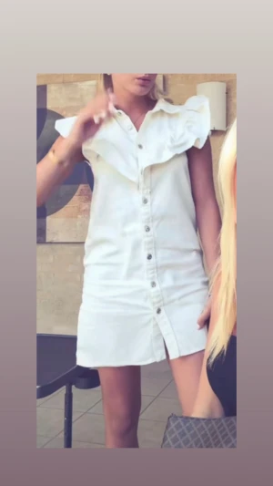 Vit kort klänning med volang från Zara - Supersnygg populär klänning från Zara med volangdetaljer. Klänningen är i storlek XS. Använd fåtal gånger så mycket bra skick!💓