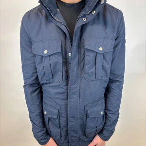 Woolrich Jacka  - Hej! Säljer nu denna väldigt snygga och eftertraktade Woolrich Fieldjacka! Jackan är slutsåld överallt och går inte att få tag på… jackan är perfekt nu till hösten/vintern  Storlek L Ny pris: 6000 kr Säljs för: 1499 kr