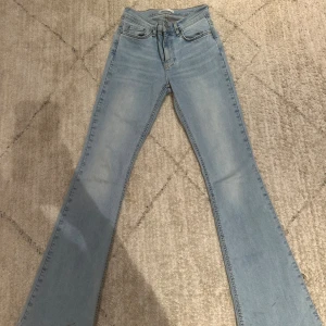 Ljusblå bootcut jeans från Gina tricot.  - Säljer ett par ljusblå jeans från Gina tricot i storlek 34. Modellen har klassisk femficksdesign, bootcut-ben och normal passform. Jeansen är tillverkade i mjukt denimtyg och har en snygg, enkel look som passar till det mesta.