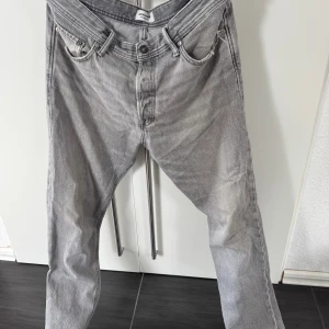Grå loose fit jeans Jack & Jones - Grå jeans från Jack & Jones i loose fit-modell, modellen heter Loose/Chris. Klassisk femficksdesign med raka ben och snyggt tvättad finish. Tillverkade i bomull för en skön och avslappnad känsla.
