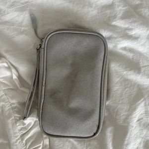 Grå necessär  - Perfekt för att organisera tech-prylar.