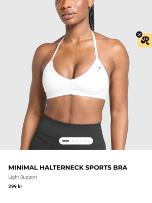 Vit halterneck sport-bh från Gymshark - Helt oanvänd vit sport-bh med halterneck och lätt stöd från Gymshark. Snygg design med smala axelband och öppen rygg, perfekt för träning. Tillverkad i stretchigt material som andas.