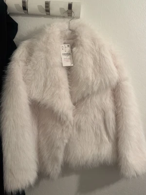 Vit pälsjacka - Säljer en trendig vit supermjuk och fluffig pälsjacka från shein i storlek S med prislappen på. Jackan har 2 fickor på sidorna. Perfekt för dig som vill ha en stil med lyxig vibe. 