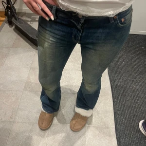 Blå bootcut jeans från Weekday - Säljer ett par blå bootcut jeans från Weekday i storlek W28 L32. Jeansen har snyggt slitna detaljer och en klassisk femficksmodell. De är tillverkade i bomull och har en mörk tvätt med ljusare partier på låren. Aldrig använda. Hör gärna av er vid frågor eller funderingar! 💞