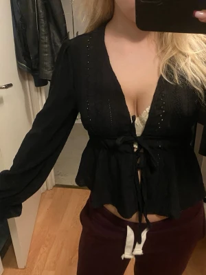 svart blus - Långärmad tröja med volang detaljer