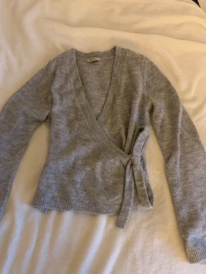 Grå kofta - Grå omlottkofta från Ginatricot, väldigt bra skick. 