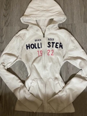 Hollister California White Zip-Up Hoodie - - In relatively good condition, missing hood thread as well as spotty on the left arm as seen in 4th pic - Size EU 40 / L, small in size so fits XS/S