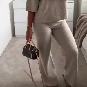 Beige stickade mjukisbyxor wide - Mysiga beige stickade mjukisbyxor med wide passform. Perfekta för en chill och avslappnad look, med mjukt material som känns skönt mot huden. Byxorna har en enkel design utan synliga detaljer och är lätta att matcha med andra plagg.