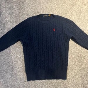 Stickad Polo Ralph lauren tröja - Säljer en mörkblå stickad tröja från Polo Ralph Lauren|| Ny pris 2100kr, mitt pris 599kr💵!|| Den är i nyskick och perfekt nu för hösten då den är varm! Skriv för fler bilder, frågor. Pris kan diskuteras vid snabb affär!🤗
