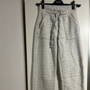 Lågmidjade mjukisbyxor  - ljusgrå lågmidjade mjukisbyxor från 157 i storlek XS. Rak modell 