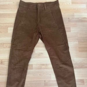 Nya. Bruna manchesterbyxor från KappAhl - Snygga bruna manchesterbyxor från KappAhl i storlek 36. Byxorna har klassisk rak passform, bälteshällor, sidfickor fram och två fickor bak. Perfekta för dig som gillar retrovibbar och mjukt material. Midja 80cm, Ordpris 499kr, nu 200kr ej prutbar.