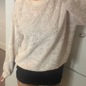 Ljusrosa fluffig tröja  - Supermjuk och fluffig ljusrosa tröja . Tröjan har långärmad passform, ribbade muddar och är gjord i ett mysigt syntetmaterial som känns som fleece. Perfekt för kyliga dagar när du vill vara både bekväm och snygg. Storlek M men passar även s och xs