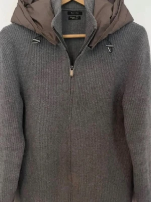Cardigan med luva - Unik massimo dutti cardigan med luva. Väldigt ovanlig. Snygg grå stickad cardiganjacka från massimo dutti med dragkedja och brun vadderad huva. Jackan har ribbstickad struktur och cool detaljer vid huvan. Perfekt för lager-på-lager och chill höststil. 