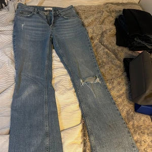 Blå jeans med slitningar - Snygga blå jeans från Perfect Jeans i storlek 36. De har en cool slitning på ena benet och en klassisk femficksdesign. Perfekta för en avslappnad stil.