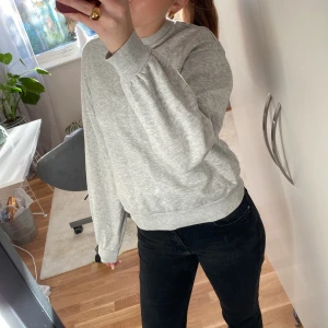 Grå sweatshirt från Gina tricot (kontakta mig innan köp) - Säljer en enkel och bekväm grå sweatshirt från Gina tricot. Perfekt för vardagsbruk med sin mjuka och sköna passform. Tröjan har långa ärmar och ribbade muddar vid ärmslut och nederkant. Passar perfekt till både jeans och mysbyxor!